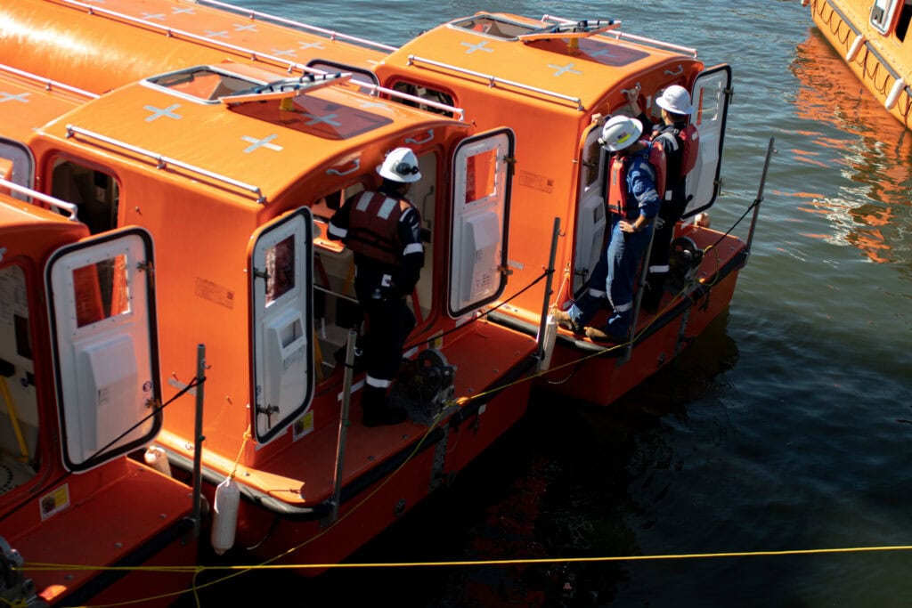 Emergency rescue boats with crew members in safety gear on the water.