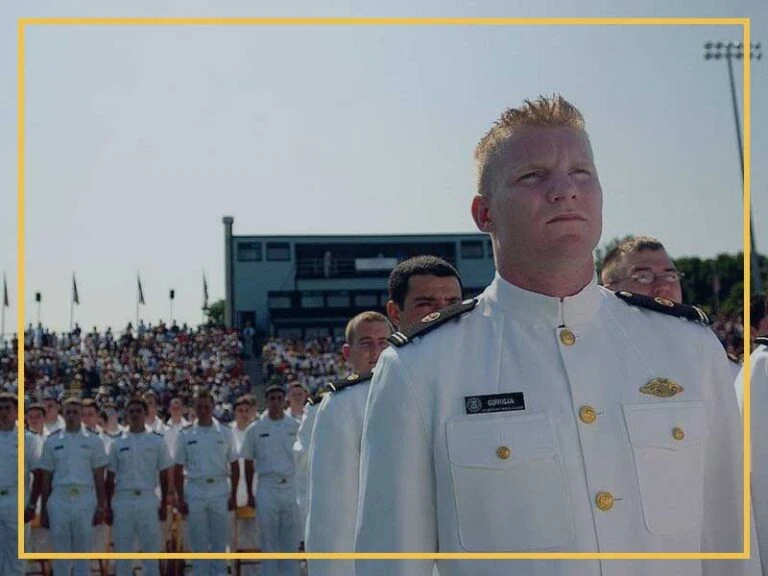 Naval officer standing in formation during a ceremony.
