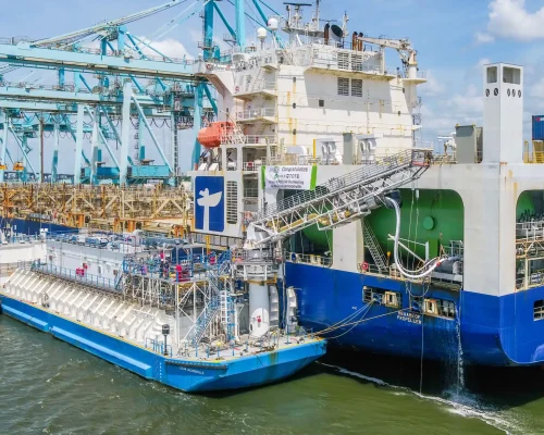Tugboats and a large cargo ship docked at the port in Jacksonville.